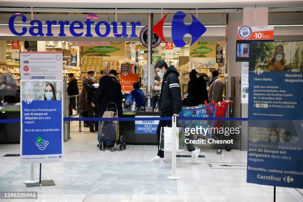 Carrefour logo is seen on display at the Carrefour supermarket entrance on January 14, 2021 in Paris, France. The Canadian distributor Couche-Tard, a...