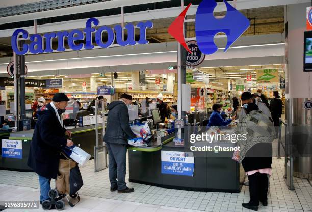 Carrefour logo is on display at the Carrefour supermarket entrance on January 14, 2021 in Paris, France. The Canadian distributor Couche-Tard, a...
