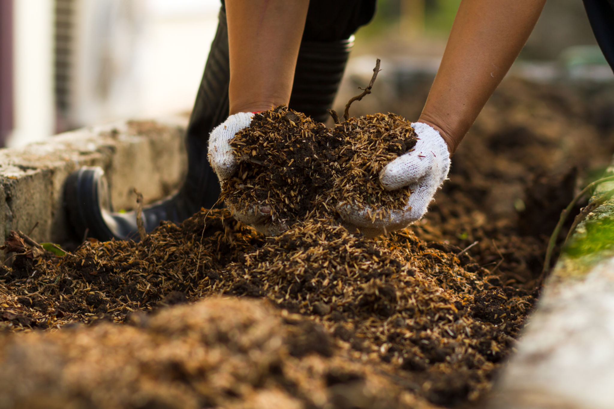 Soil mixed with compost at vegetable garden, recycle tea sachets and Kraft paper packaging Soil mixed with compost at vegetable garden, recycle tea sachets and Kraft paper packaging