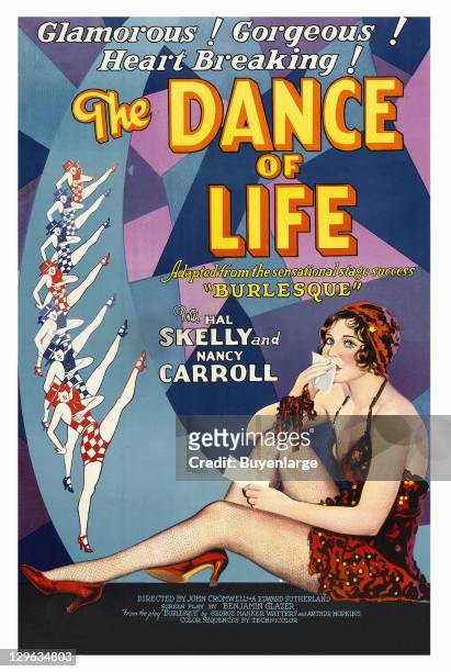 Girl in skimpy dancer's costumes kisses an envelope - a dance line of high kicking women on a poster that advertises the movie 'The Dance of Life,'...