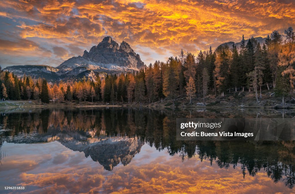 Mountain reflecting in a mountain lake at sunset.