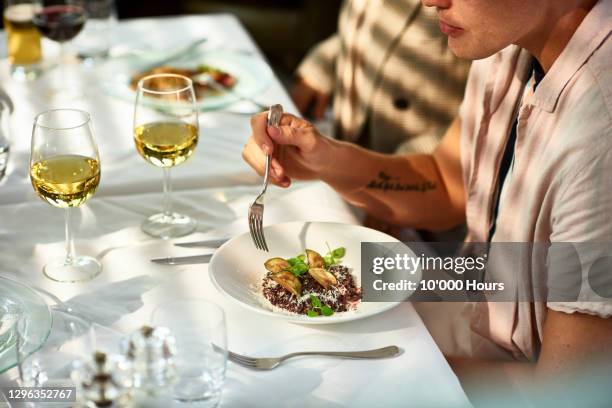 man eating gourmet food in restaurant - gourmet eten stockfoto's en -beelden