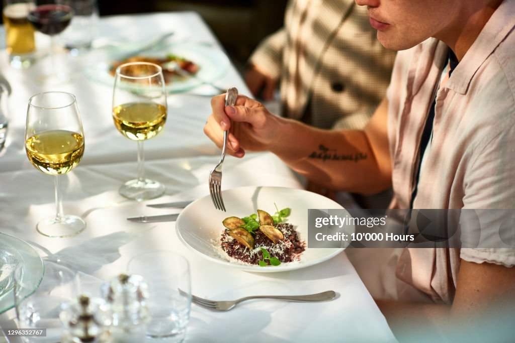 Man eating gourmet food in restaurant