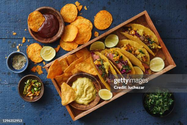 mexican crunchy taco shells with beef and vegetables - mexican food on table stock pictures, royalty-free photos & images