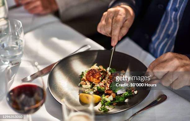man eating freshly prepared meal in restaurant - gourmet fotografías e imágenes de stock