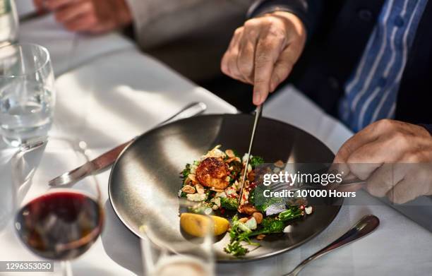 man eating freshly prepared meal in restaurant - fine dining ストックフォトと画像