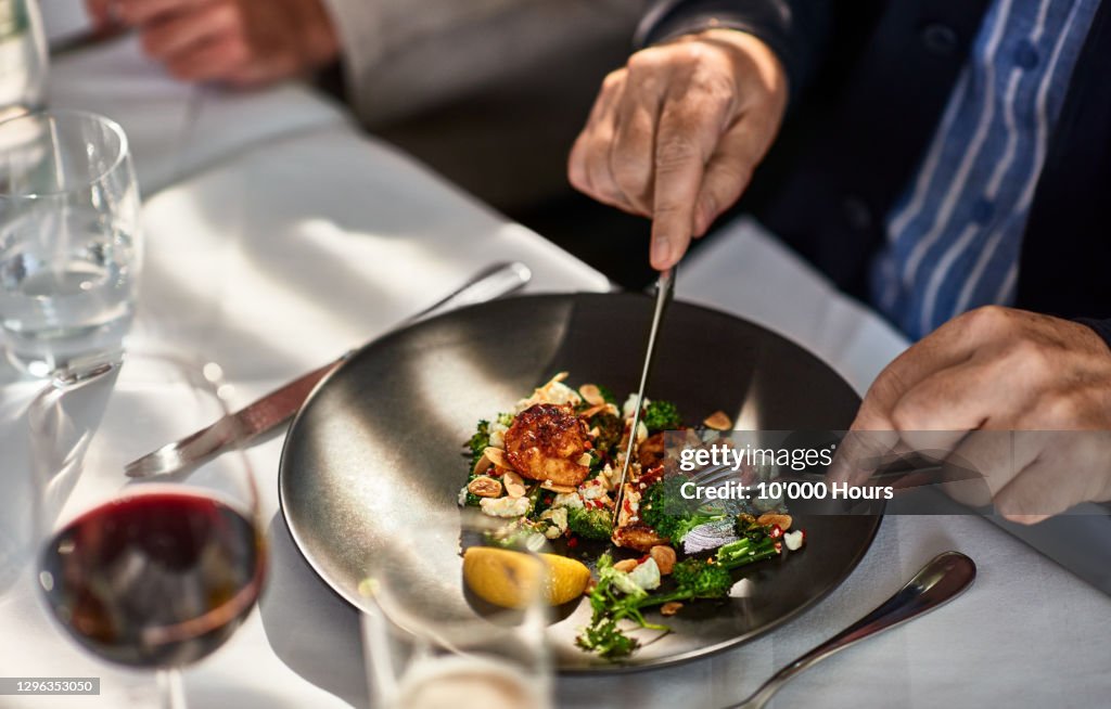 Man eating freshly prepared meal in restaurant