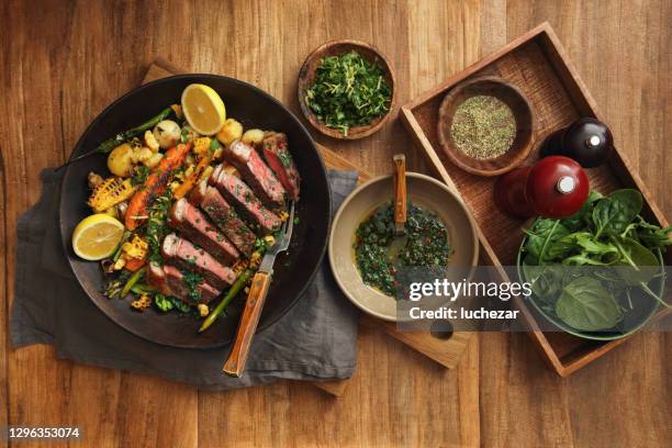 argentinian grilled steak with roasted root vegetables - chimichurri stock pictures, royalty-free photos & images