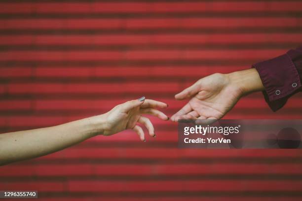 closeup of male and female hands touching with their fingers - trust god stock pictures, royalty-free photos & images