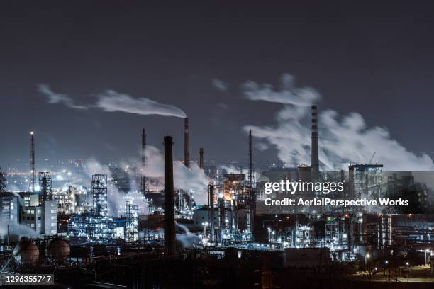 aerial view of petrochemical plant and oil refinery industry at night - factory smog stock pictures, royalty-free photos & images