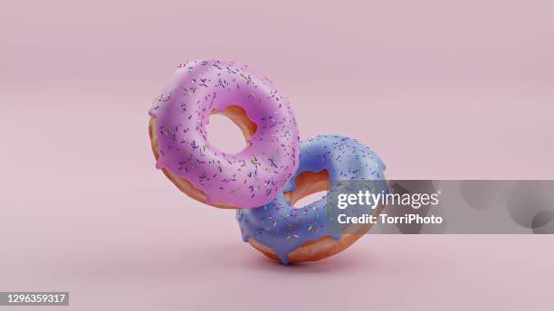 pink and blue donuts on pink background - pop fly fotografías e imágenes de stock