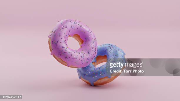 pink and blue donuts on pink background - beignet photos et images de collection