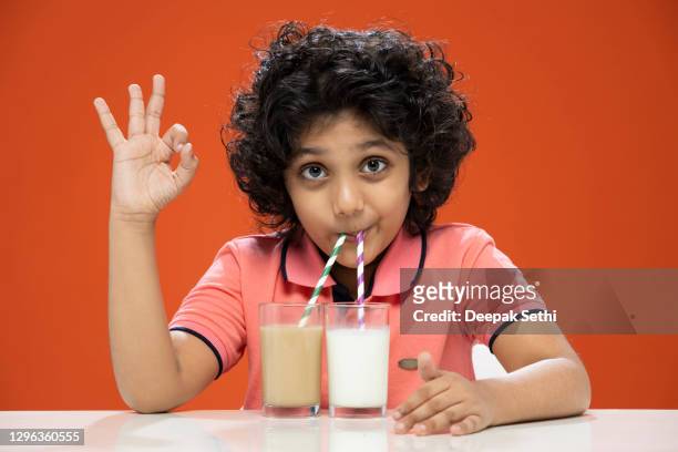 child boy drinking milk and chocolate shake -stock photo - chocolate milk stock pictures, royalty-free photos & images