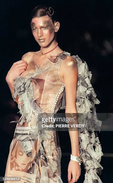 Model presents a "Christian Dior Daily" newspaper-inspired dress by John Galliano for Christian Dior during the Autumn-Winter 2000/2001 ready-to-wear...