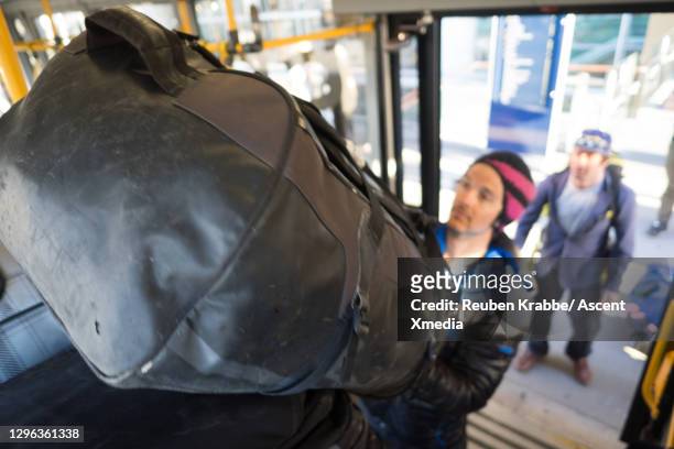 athletes load bus with bags at airport - forward athlete stock pictures, royalty-free photos & images
