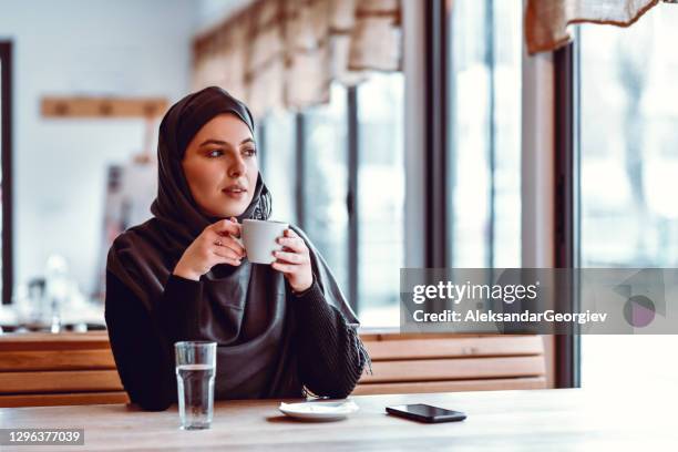 coffee time for modern muslim female in restaurant - turkish coffee drink stock pictures, royalty-free photos & images