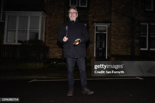 Resident on a street in Saltburn stands outside his home and takes part in the Clap for Heroes event on January 14, 2021 in Saltburn-by-the-Sea,...