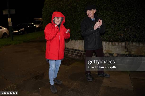 Couple applaud as they take part in the Clap for Heroes event on January 14, 2021 in Saltburn-by-the-Sea, England. During the first Coronavirus...