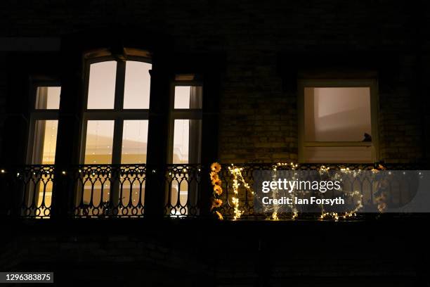 Balcony is decorated with flowers spelling out "NHS" during the Clap for Heroes event on January 14, 2021 in Saltburn-by-the-Sea, England. During the...