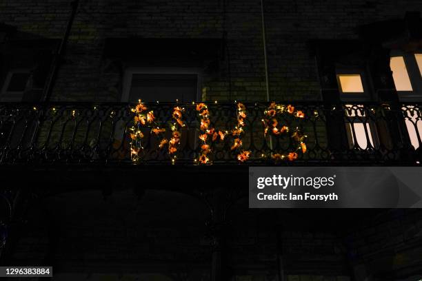 Balcony is decorated with flowers spelling out "NHS" during the Clap for Heroes event on January 14, 2021 in Saltburn-by-the-Sea, England. During the...