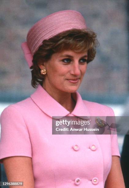Diana, Princess of Wales, wearing a pink suit designed by Versace and a pillbox hat by Philip Sommerville, during a visit to Howe Barracks on May 20,...