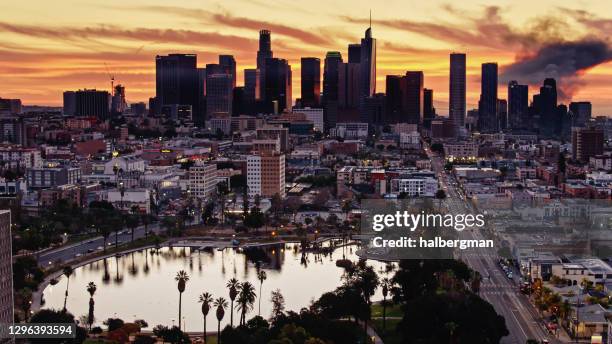 westlake-macarthur park with downtown la skyline at sunrise - aerial - los angeles park stock pictures, royalty-free photos & images