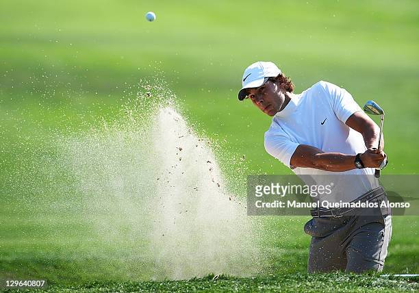Rafael Nadal of Spain plays out of a bunker during the pro - am prior to the start of the Castello Masters Costa Azahar at the Club de Campo del...