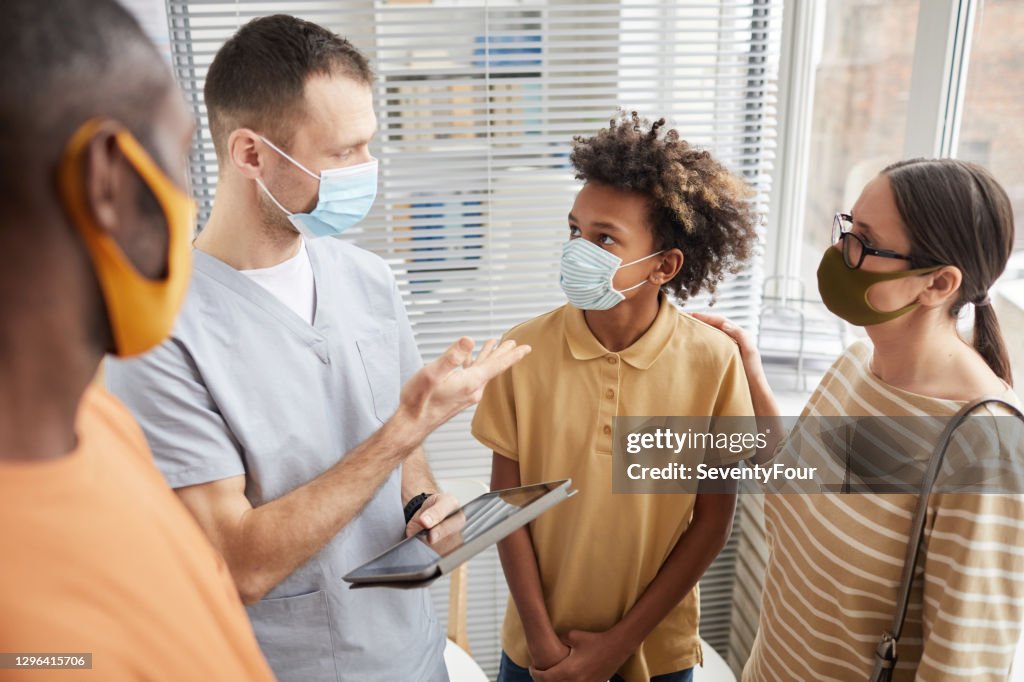 Doctor Talking to Family in Clinic