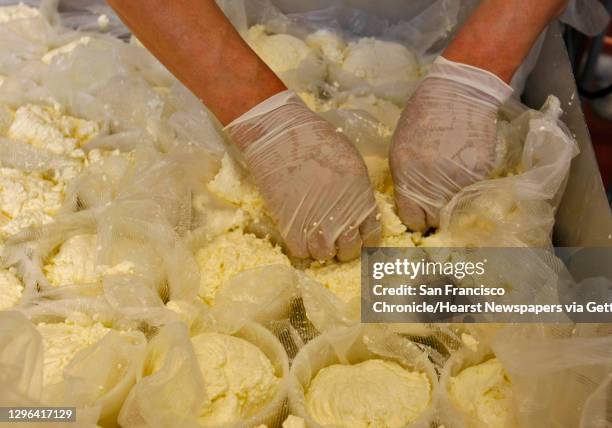 Miguel Martinez works with the cheese curds to make the Red Hawk triple cream at the Cowgirl Creamery, Thursday Feb. 5 Point Reyes Station, Calif....