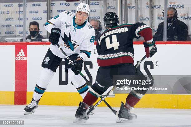 Timo Meier of the San Jose Sharks skates with the puck against Niklas Hjalmarsson of the Arizona Coyotes during the first period of the NHL game at...
