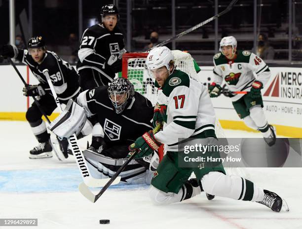 Marcus Foligno of the Minnesota Wild controls the puck from his knees in front of Jonathan Quick of the Los Angeles Kings during the first period in...