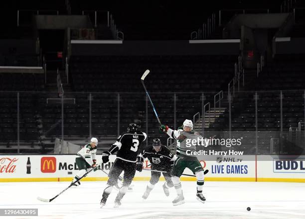 Nick Bjugstad of the Minnesota Wild reacts as he is checked for the puck by Anze Kopitar of the Los Angeles Kings during the first period in the...