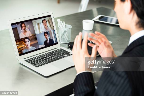 un uomo d'affari che indossa abiti sta facendo riunioni online in un ufficio - isolamento foto e immagini stock