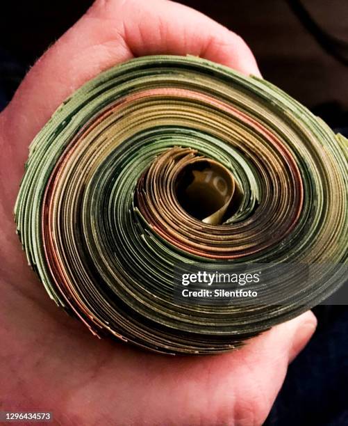 cash in hand - canadian money stock pictures, royalty-free photos & images