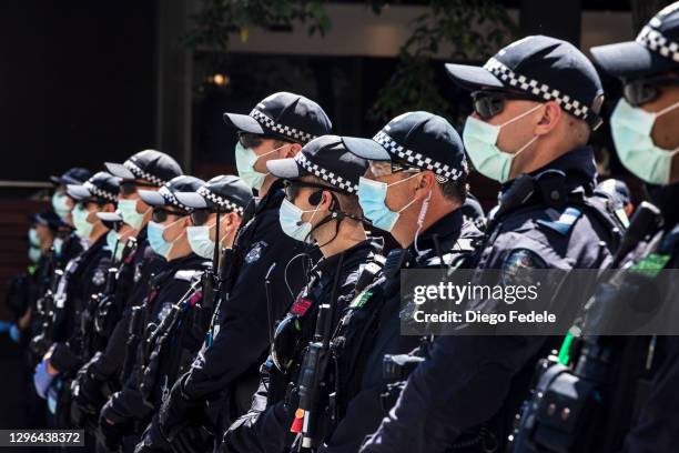 Police stand watch in front of the Park Hotel on January 09, 2021 in Melbourne, Australia. There have been ongoing protests outside the Park Hotel in...