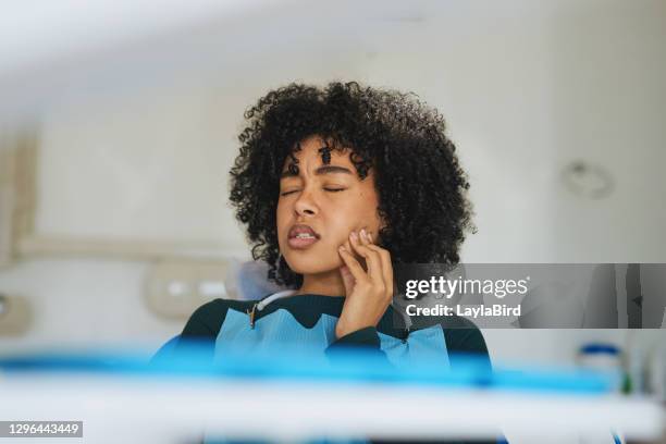 she's come to the right place for that tooth pain - african injured stock pictures, royalty-free photos & images