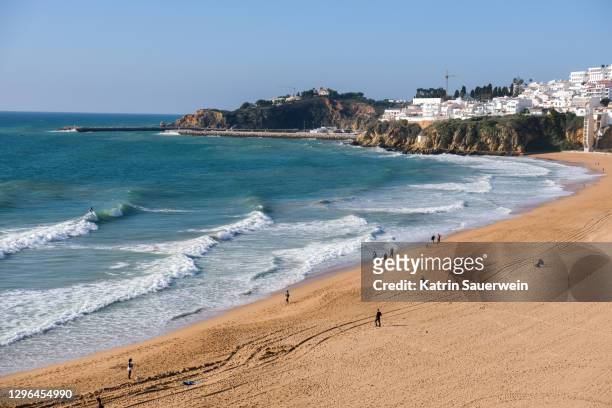 scenic view of beach against clear sky - albufeira stock pictures, royalty-free photos & images