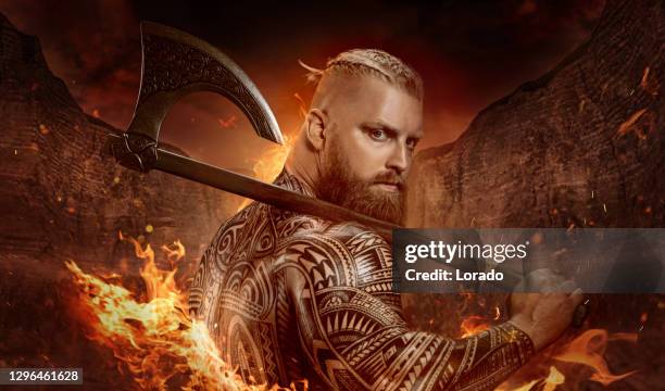 weapon wielding viking inspired warrior in a fantasy fire setting - fantasy warrior stock pictures, royalty-free photos & images