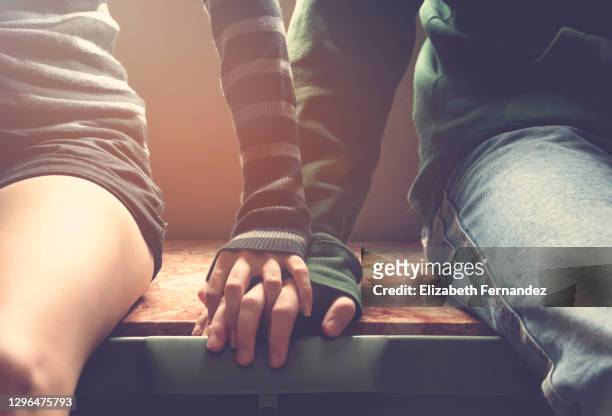 young couple holding hands - touching stock pictures, royalty-free photos & images