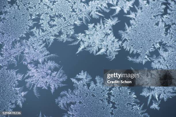 frost on a glass with blue background - frosted glass ストックフォトと画像