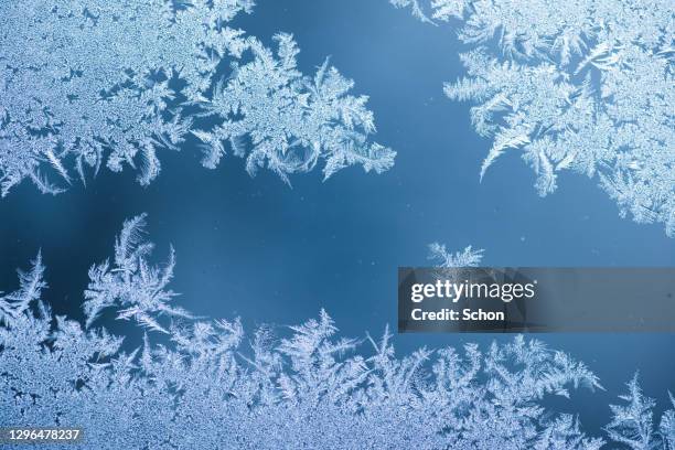 frost on a glass with blue background - frosted glass ストックフォトと画像