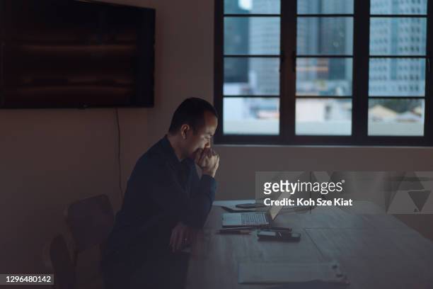 Asian businessman focused at work in office