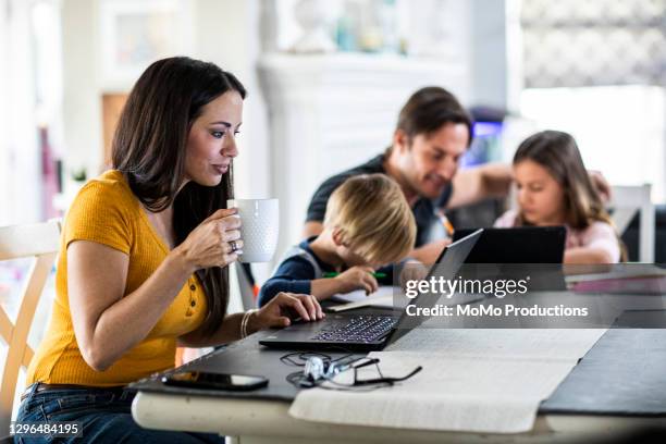 mother working from home while children attend school online - american dad imagens e fotografias de stock