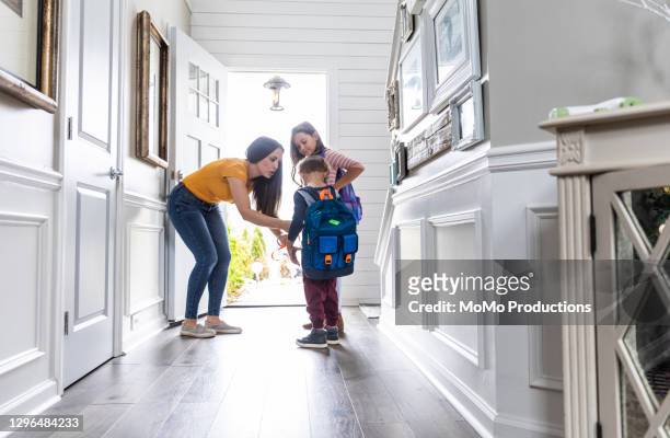 mother getting children ready for school - preparazione foto e immagini stock