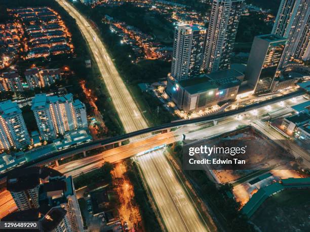 drone point of view directly above downtown district at night with powerline and illuminated by street lights - petaling jaya stock pictures, royalty-free photos & images