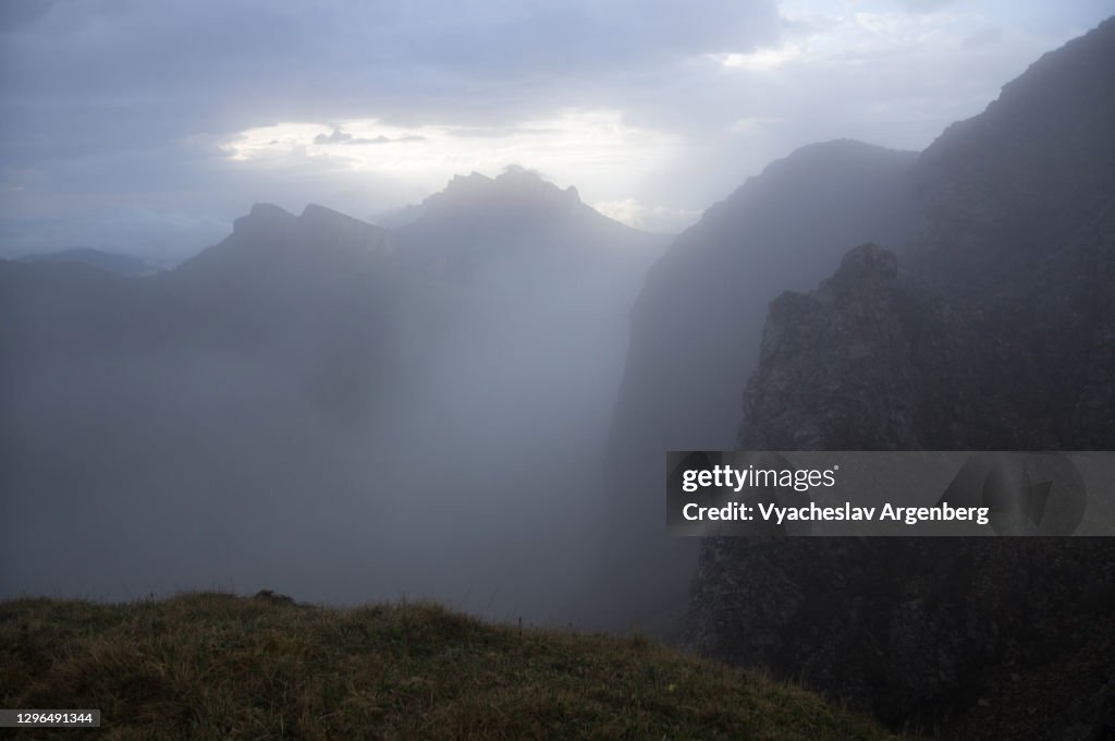 Hiking the slopes of Asbestnaya Mount in heavy fog and clouds, Adygea, Caucasus Mountains