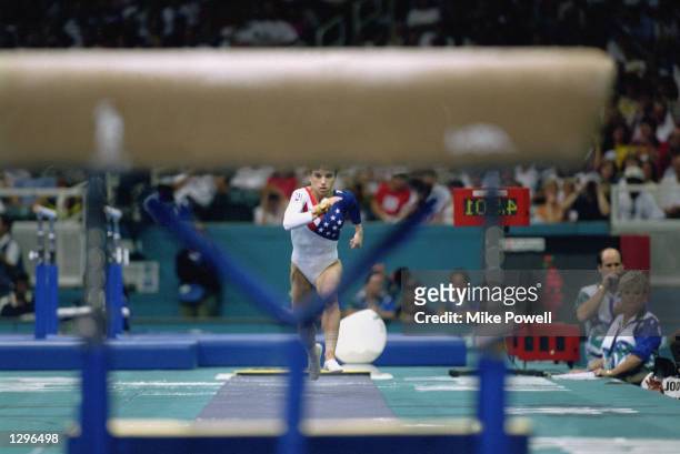 Kerri Strug of the United States hurls herself down the runway while competing in the vault, part of the Womens Team Gymnastics competition at the...
