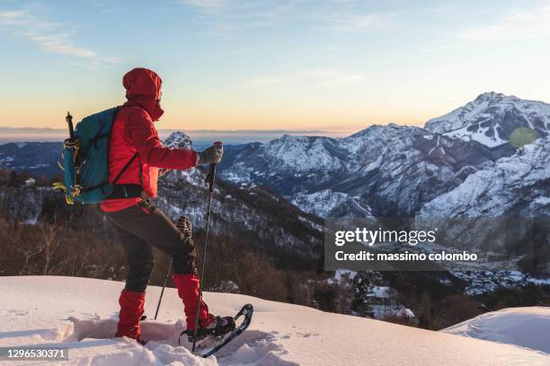 hiker with snowshoes snowy mountain - schneeschuh stock-fotos und bilder