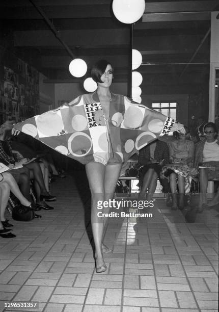 Batwing sleeves and a neckline slit to below the waist is a Rudi Gernreich message for resort wear. The California designer calls it his "Batwing...