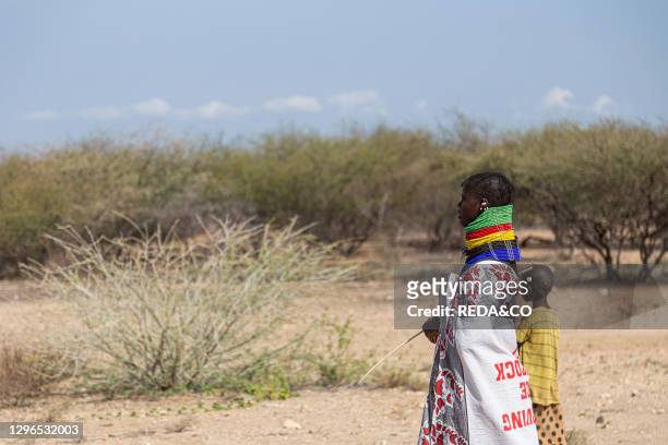 Traditional mother and son in the Turkana Desert. Turkana County. Kenya. Africa.